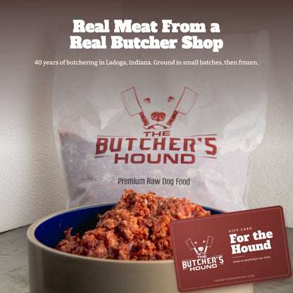Butcher's Hound raw dog food in a bowl beside its bag, with a gift card in front